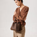 Medium Song Bag in Chocolate textured leather with gold hardware. Stylish, functional leather bag.