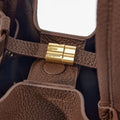 Medium Song Bag in chocolate brown, featuring textured leather, a golden Songmont logo clasp, and a spacious interior.