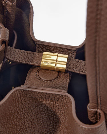 Medium Song Bag in chocolate brown, featuring textured leather, a golden Songmont logo clasp, and a spacious interior.