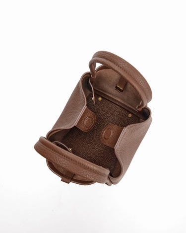 Medium Song Bag in chocolate brown full-grain leather, showing interior with magnetic closure and brass hardware.