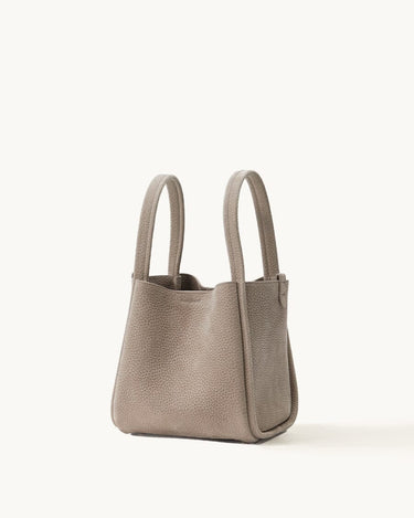 Medium Song Bag in Haze nubuck leather, structured O-shape design with dual top handles.
