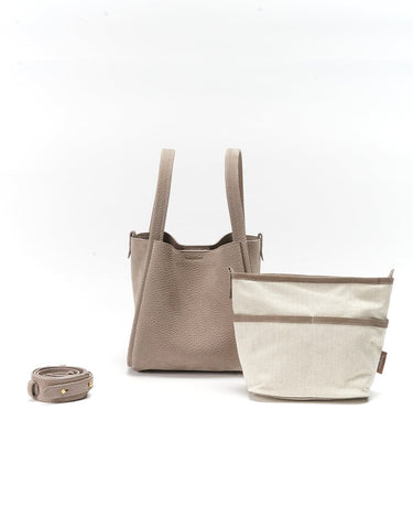 Medium Song Bag in Haze nubuck leather with a removable canvas inner pouch and adjustable strap.
