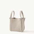 Medium Song Bag in Ivory pebble-grain leather with short handles.
