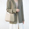 Ivory pebbled leather Medium Song Bag with single handle and flap closure. Chic everyday style.