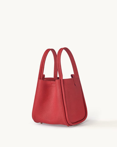 Medium Song Bag in Lucky Red full-grain leather, a structured bucket bag with dual top handles and protective metal feet.