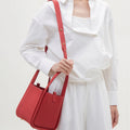 Medium Song Bag in Lucky Red full-grain leather with adjustable strap and gold hardware