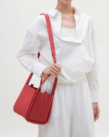 Medium Song Bag in Lucky Red full-grain leather with adjustable strap and gold hardware