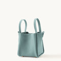 Mint green full-grain leather medium song bag with top handles and magnetic closure