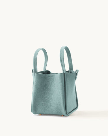 Mint green full-grain leather medium song bag with top handles and magnetic closure