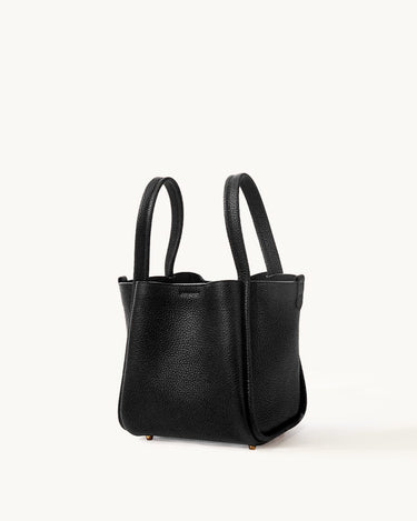 Medium Song Bag in black full-grain leather with dual top handles and protective metal feet.