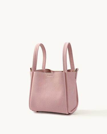 Medium Song Bag in pink textured leather, a stylish bucket bag with dual handles.