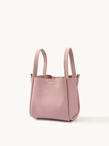 Medium Song Bag in pink textured leather, a stylish bucket bag with dual handles.