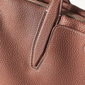 Medium Yore Duffle Bag in Golden Brown full-grain leather with contrast stitching and brass zippers.