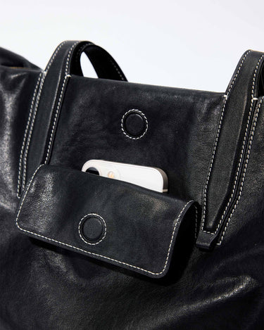 Black leather Medium Yore Duffle Bag with front phone pocket and white stitching