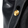 Medium Yore Duffle Bag in Onyx black leather with white contrast stitching and gold hardware detail.