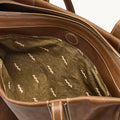 Brown leather Medium Yore Duffle Bag interior with unique patterned lining and open main compartment.