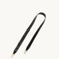Black leather shoulder strap with white stitching and gold clasps for the Medium Yore Duffle Bag.