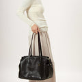 Medium Yore Duffle Bag in black vegan leather, a stylish and functional travel bag with textured finish.