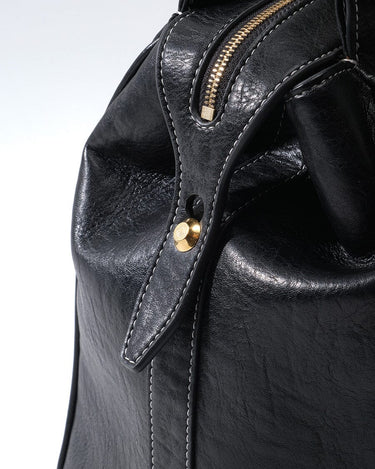 Medium Yore Duffle Bag in Onyx: Textured vegan leather with gold zipper and white stitching.