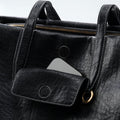 Medium Yore Duffle Bag in Onyx vegan leather, featuring a phone pocket and gold hardware.