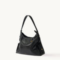 Medium Yore Hobo Bag in Onyx leather, featuring white stitching, adjustable strap, and exterior pockets.