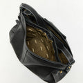Medium Yore Hobo Bag in Onyx black vegetable-tanned leather with white stitching and wavy interior lining.
