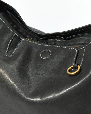 Medium Yore Hobo Bag in Onyx with textured leather, white stitching, and gold hardware detail.