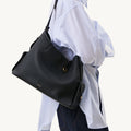 Medium Yore Hobo Bag in Onyx Grain textured full-grain leather with white stitching and gold hardware