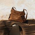 Medium Yore Hobo Bag in Sandal Suede, featuring cow suede leather and vegetable-tanned leather with gold-toned hardware.