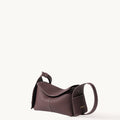 Burgundy Mini Drippy Roof Bag in textured full-grain leather with white stitching.