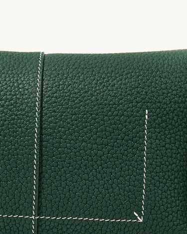 Mini Drippy Roof Bag in emerald green pebbled leather with white contrast stitching. Architectural design.