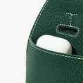 Mini Drippy Roof Bag in emerald green leather, showing a pocket with a white earbud case.