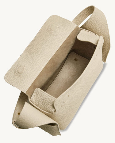 Mini Drippy Roof Bag in ivory textured leather, open to reveal microfiber lining and interior compartment.