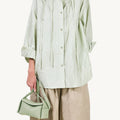 Mini Drippy Roof Bag in light green full-grain leather with gold hardware.