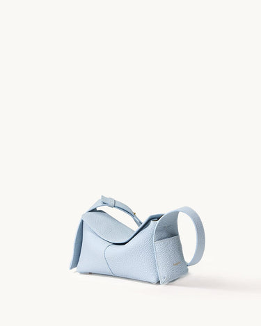Pale blue full-grain leather mini drippy roof bag with stainless steel hardware and adjustable strap.