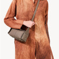 Taupe Mini Drippy Roof Bag: textured leather, gold hardware, unique architectural design.