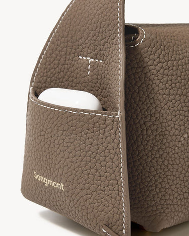 Taupe Mini Drippy Roof Bag: textured leather, front pocket with earbuds, white stitching, gold Songmont logo.