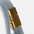 Sky Mini Song AirPods Case with gold hardware and Songmont logo.