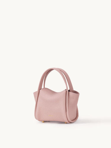 Pink Mini Song Bag made of full-grain leather with gold hardware and adjustable strap