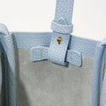 Sky blue leather Mini Song Bag interior detail with adjustable strap and gold hardware.