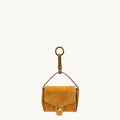 Ochre Mini Yore AirPods Case made of suede with a gold-tone clasp and keychain attachment.