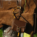 Mini Yore AirPods Case in Sandal color, made of vegetable-tanned leather, attached to a brown suede bag with leather trim.