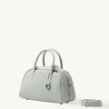 Mini Yore Bowling Bag in Celeste pebble-grain leather with rolled handles and detachable strap.