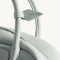 Mini Yore Bowling Bag in Celeste, showing textured leather and embossed Songmont logo detail.