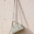 Mini Yore Bowling Bag in Celeste: textured full-grain leather with silver hardware and detachable strap.