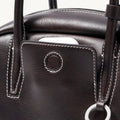 Ebony Mini Yore Bowling Bag: Full-grain nappa leather, white stitching, silver hardware details.