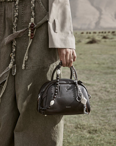 Mini Yore Bowling Bag in ebony pebbled leather with decorative beads and 'Songmont' logo.