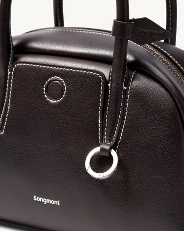 Mini Yore Bowling Bag in dark brown full-grain Nappa leather with white stitching and silver hardware.