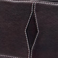Mini Yore Bowling Bag in ebony full-grain leather with white contrast stitching and diamond detail.