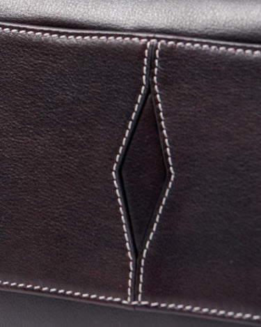 Mini Yore Bowling Bag in ebony full-grain leather with white contrast stitching and diamond detail.